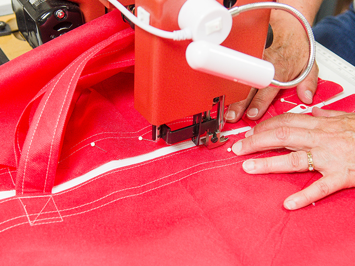 Sewing the zipper to the top of the bag.